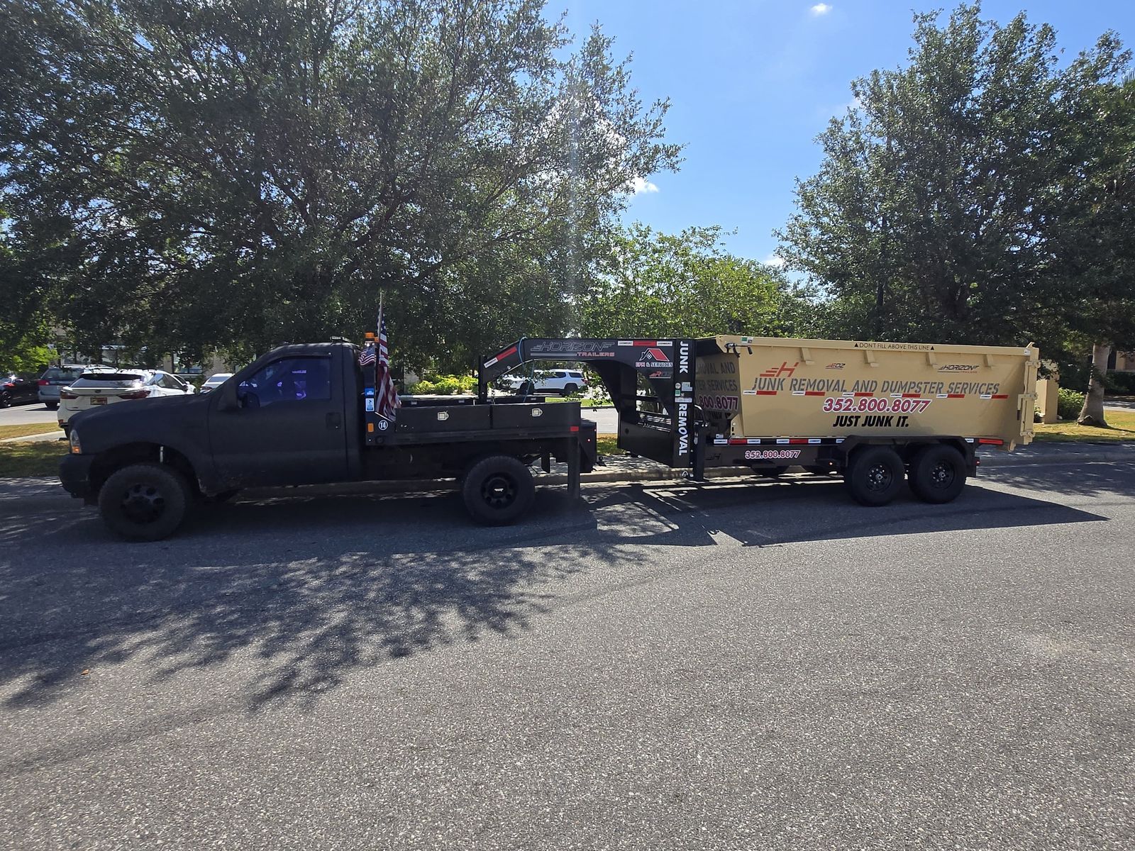 Junk removal dumpster trailer and truck for EPM & Services in Eustis, FL Junk removal dumpster trailer and truck for EPM & Services in Eustis, FL
