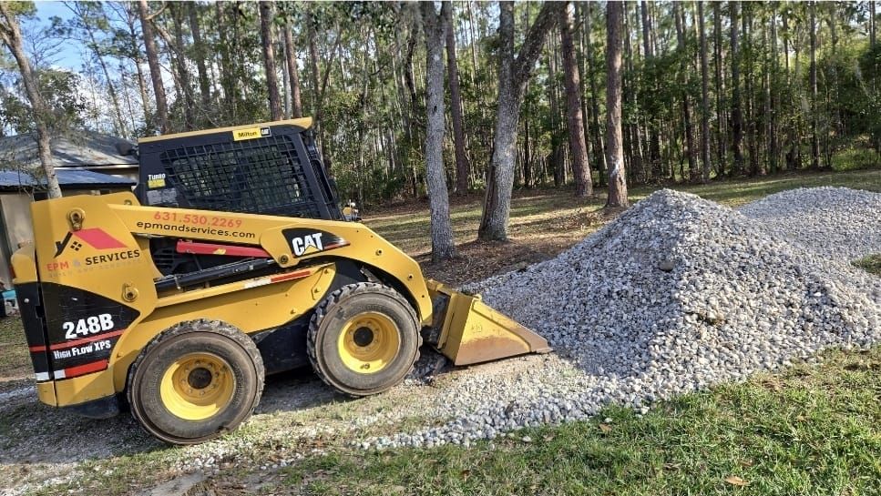 CAT skid steer spreading gravel during yard cleanup in Eustis, Florida CAT skid steer spreading gravel during yard cleanup in Eustis, Florida